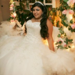 ** TO GO WITH AUSTERIDAD FIESTAS ** Yanelis Ganuzas, center,sits on a decorated swing during her quinceanera party in Hialeah, Fla, March 15, 2009. Due to the recession, many parents are cutting costs but still holding coming of age parties like quinceaneras. Decorations are being made at home, donations are sought and the entertainment is less lavish than years before. (AP Photo/Jeff. M. Boan)